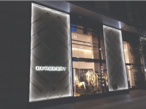 Boca Lighting and Controls edge lit glass fixtures on a retail exterior creating lighting and accents for Burberry signage.