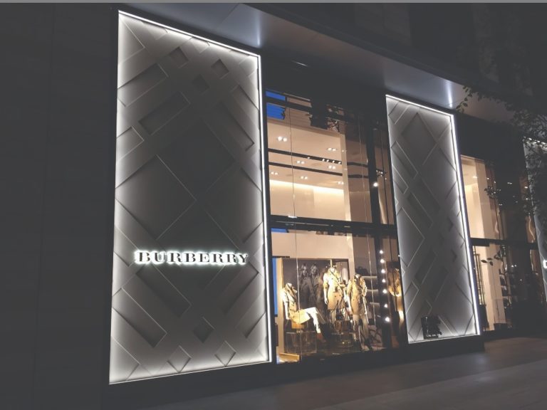 Boca Lighting and Controls edge lit glass fixtures on a retail exterior creating lighting and accents for Burberry signage.