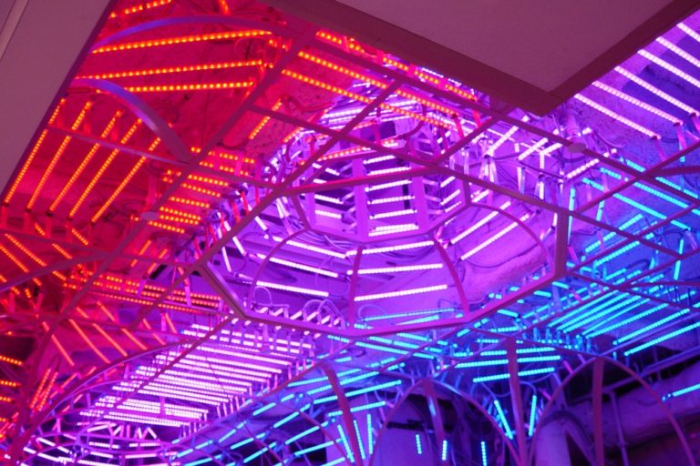 Multicolored LED strip lights with tubular enclosures creating a colorful pattern in a residential ceiling. Boca Lighting and Controls.