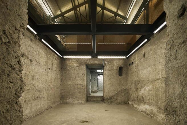 LED cove lighting and wall washing fixtures in an industrial commercial space.