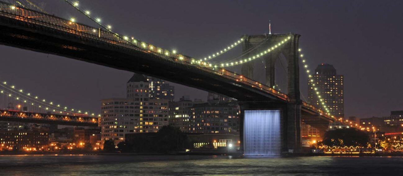 LED lighting illuminates a featured waterfall on the Brooklyn Bridge.