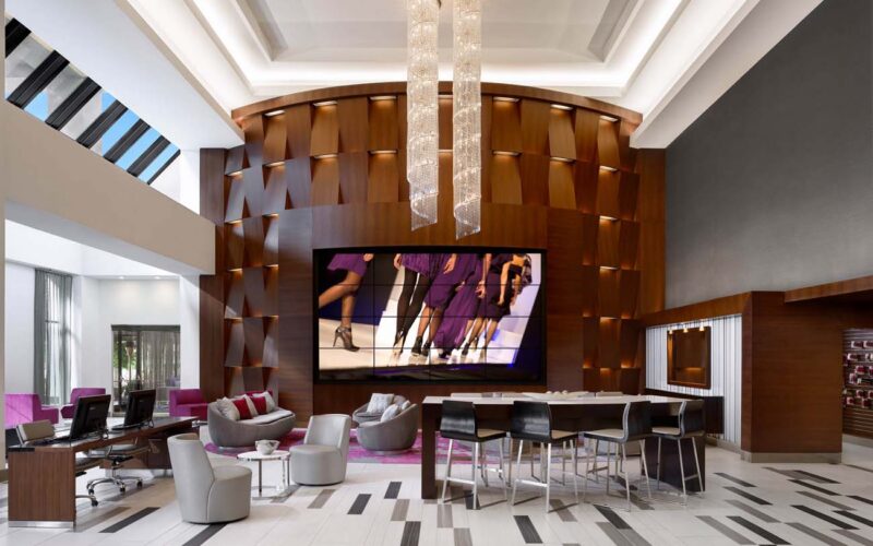 Linear cove lighting fixtures and accent lighting fixtures in a hotel lobby.