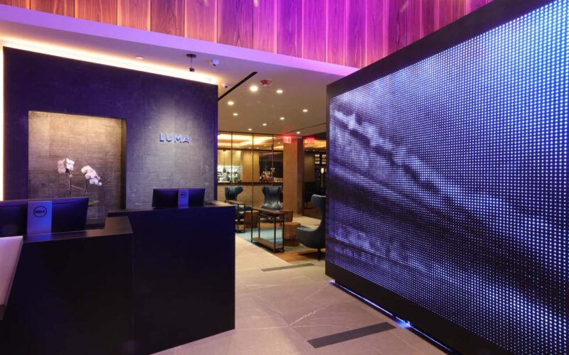 Hotel reception area with wall washing, cove lighting, and accent lighting.