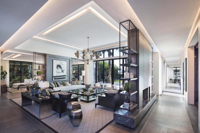 LED cove lighting fixtures accentuate the ceiling in a residential living room and hallway.