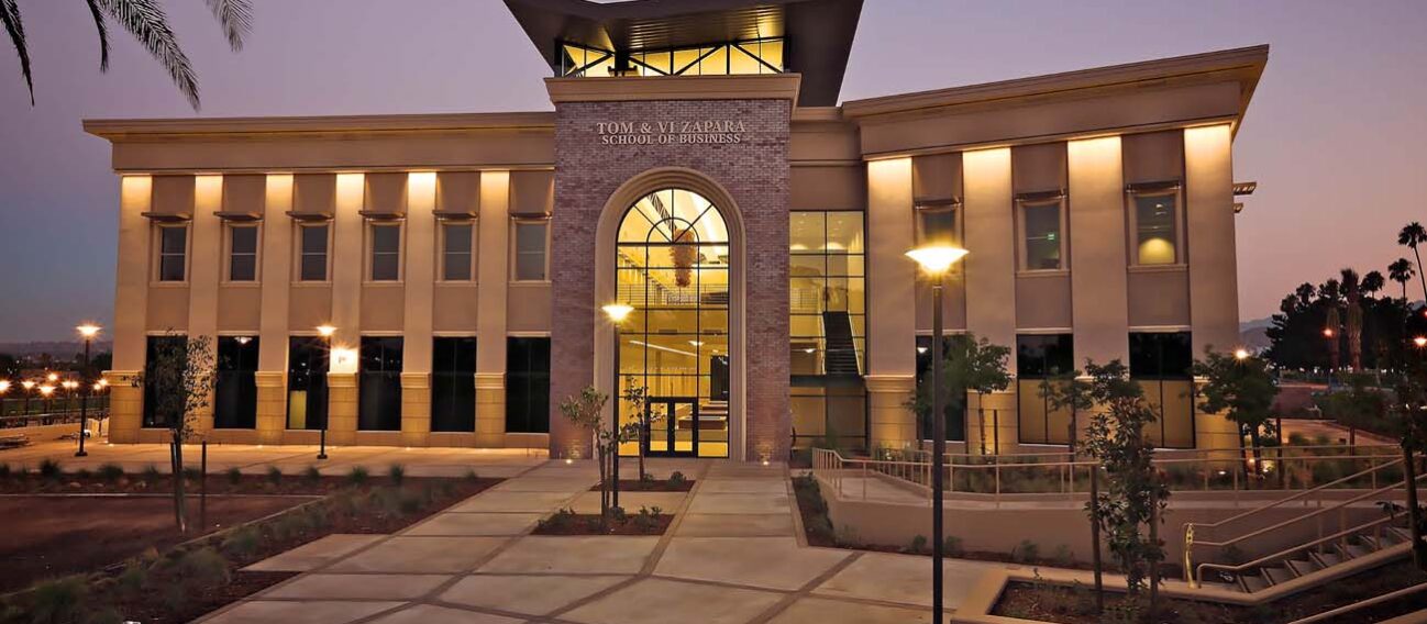 Linear LED lights illuminating the exterior of the Tom & Vi Zapara School of Business.