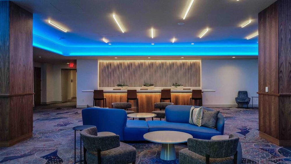 LED Lighting and Controls in the Curricular Economy Vivid blue light washes the wall of a hotel