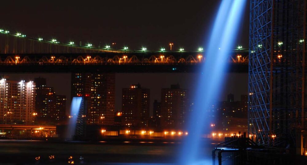 Illuminating Fountains – The Art of Water and Light Illuminated waterfall fountains flanking the Brooklyn Bridge