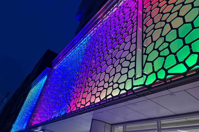 Vibrant, multicolored, exterior LED lighting washes a hotel facade