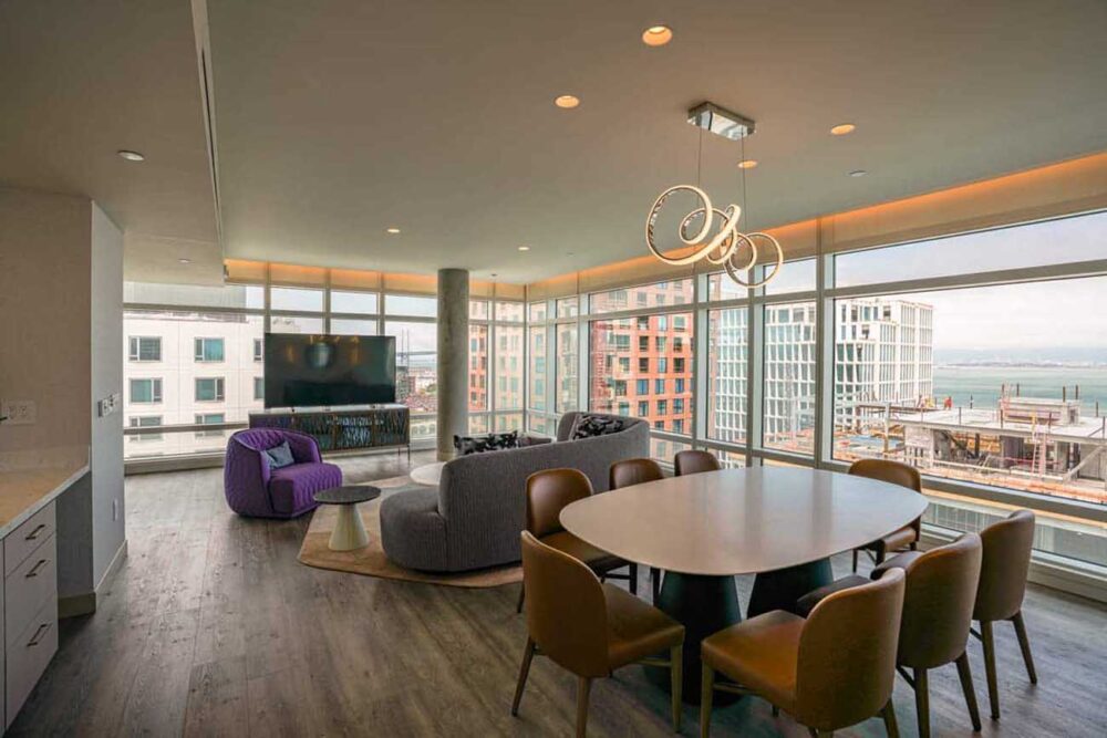 Smart Lighting Controls Cove lighting borders a combined living and dining room space