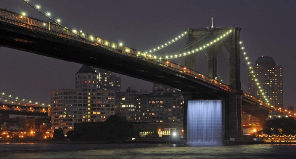 Five Elements to Consider When Lighting Statues, Monuments, and Architectural Features An illuminated waterfall fountain beneath the Brooklyn Bridge