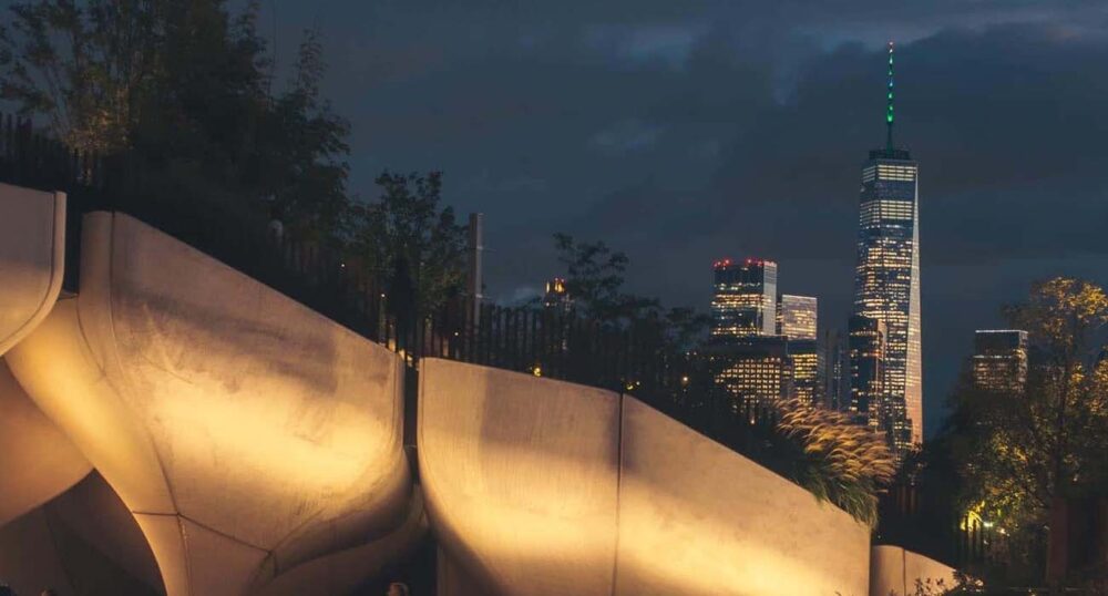 Using Light to Create a Striking Impact on Urban Infrastructure Warm flood lighting illuminates architectural forms in a public park