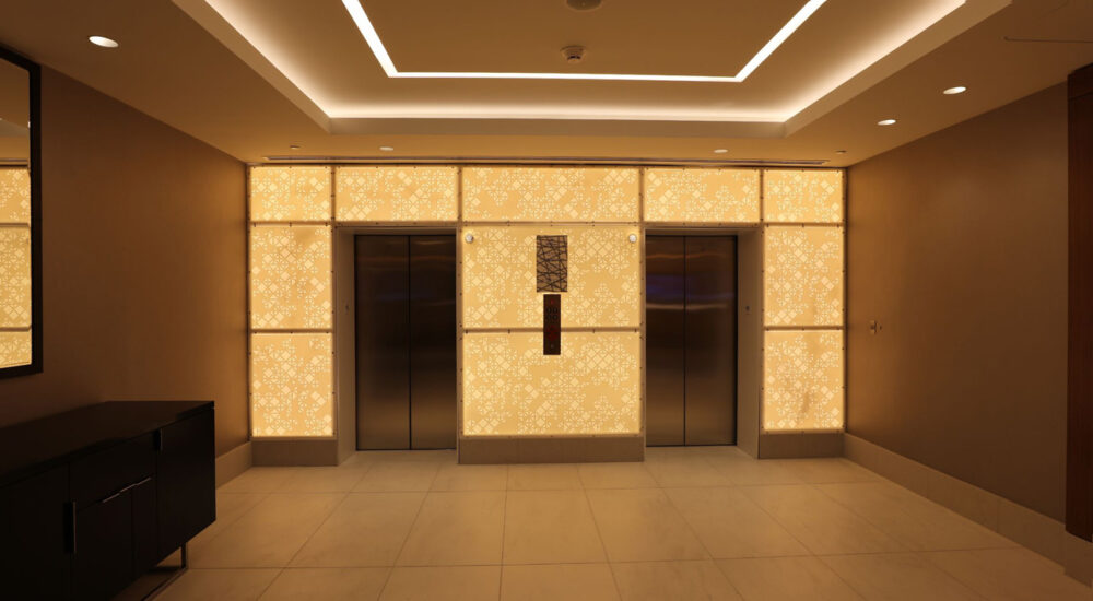 What is the Difference Between Cove Lighting & Soffit Lighting? Cove lighting accents architectural details in a hotel ceiling.