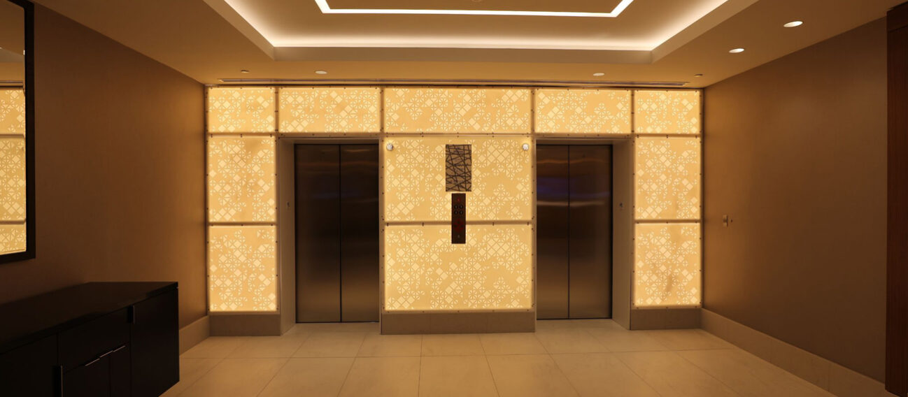 What is the Difference Between Cove Lighting & Soffit Lighting? Cove lighting accents architectural details in a hotel ceiling.